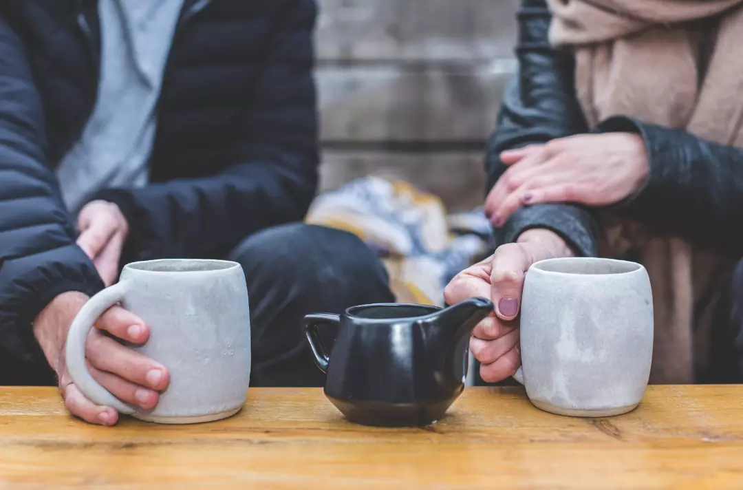 A stock photo of two people having a coffee