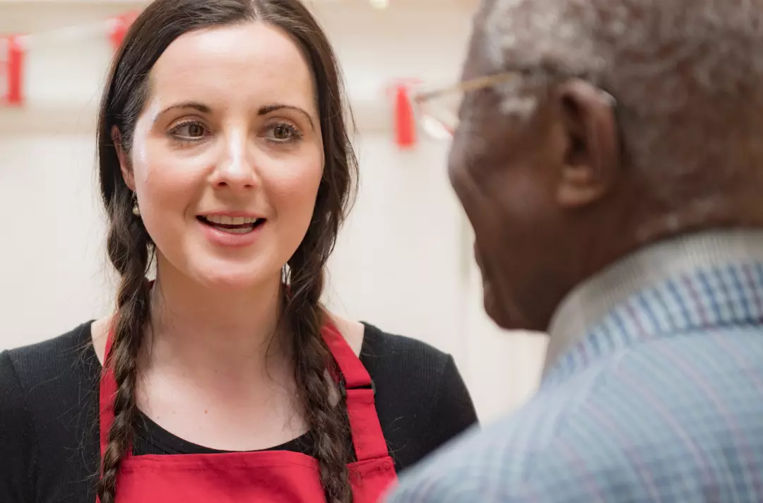 A Salvation Army volunteer talking to someone