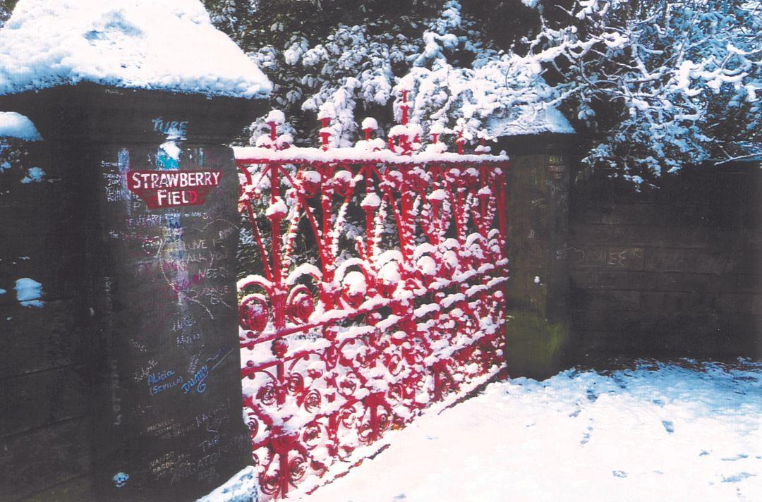 A photo of the red gates at Strawberry Field covered in snow