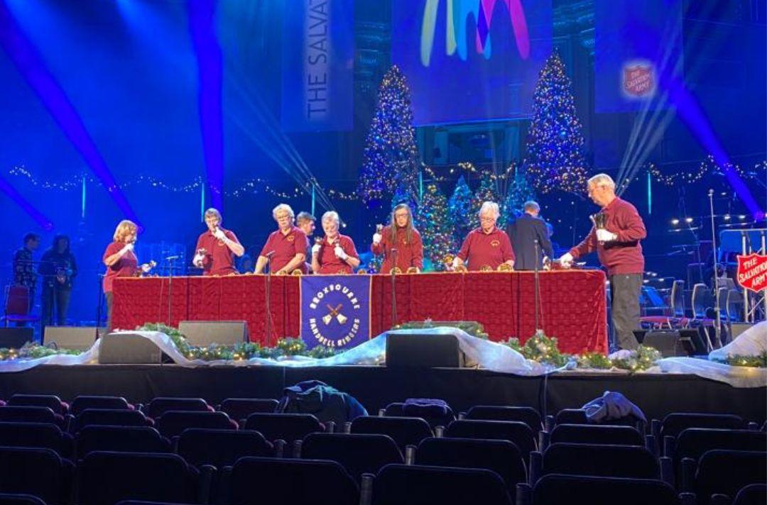 A photo of the Broxbourne Handbell Ringers rehearsing on the stage of the Royal Albert Hall