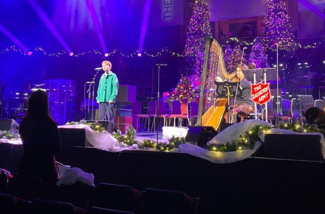 A photo of thirteen year old Cormac Thompson and harpist Alison Blackhall rehearsing on the stage of the Royal Albert Hall
