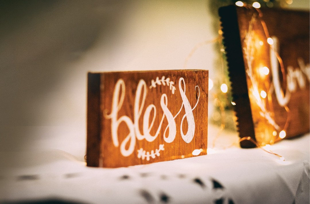 Photo shows an ornament displaying the word 'bless'.