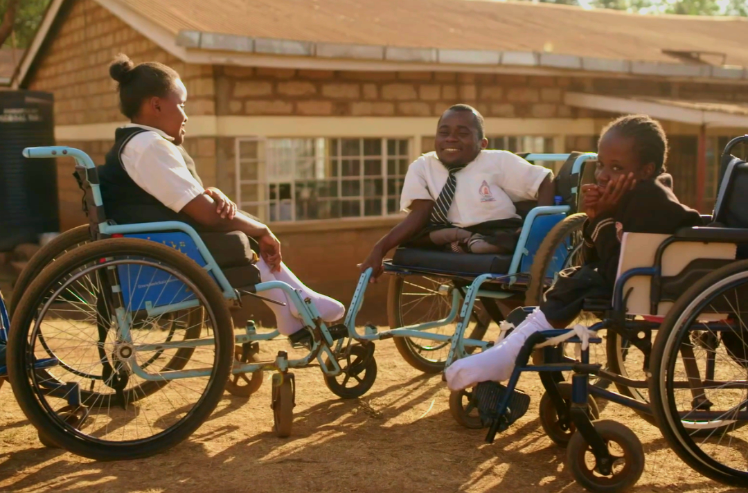 Photo shows three young people in wheelchairs.