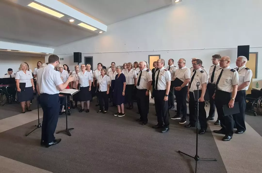 A photo of a choir, Bromley Temple Songsters, singing in the foyer of Fairfield Halls