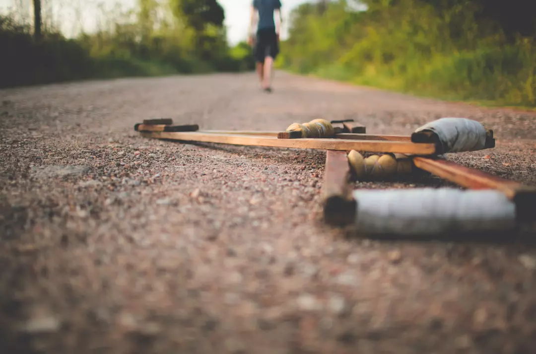 A photo shows someone walking away from old wooden crutches.