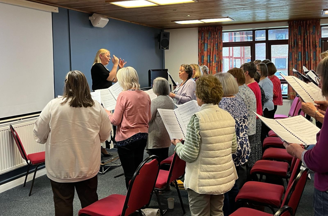 A photo shows an Easter Music Course 2024 vocal rehearsal.