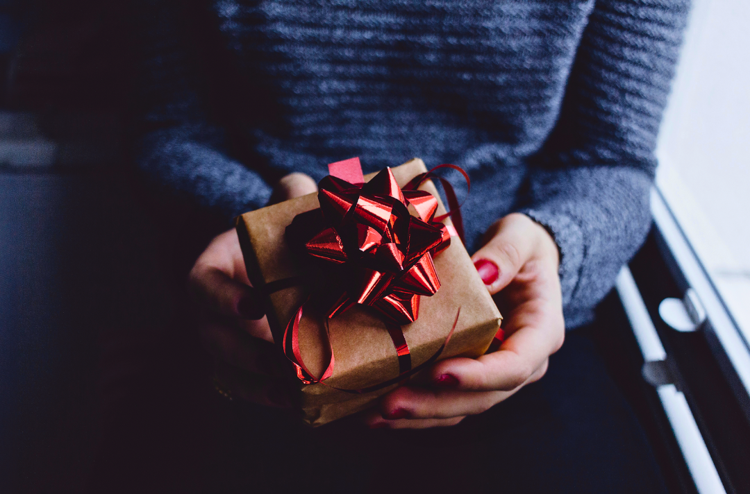 A photo shows someone holding a gift.