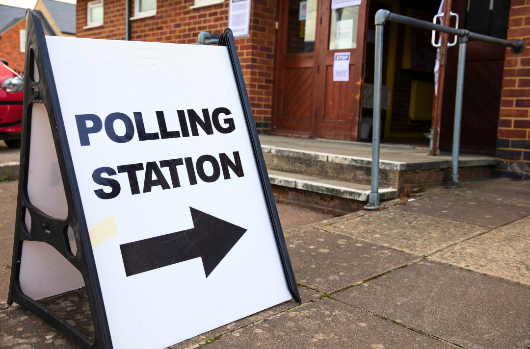 A photo shows a sign that reads: polling station.
