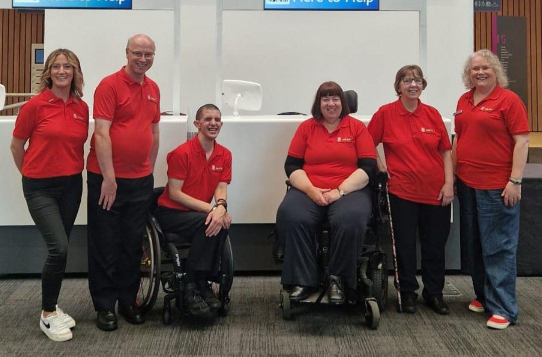 A group photo of Here to Help volunteers at Together 2024 - the group includes two wheelchair users