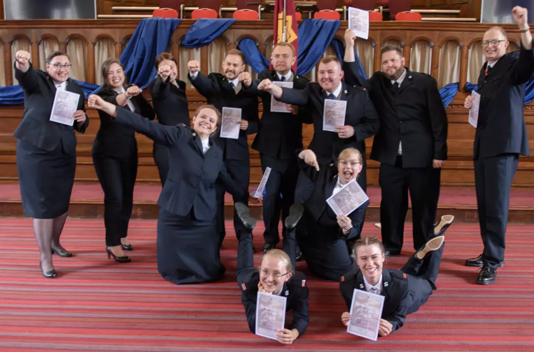 A photo shows the cadets of the Defenders of Justice session striking heroic poses.