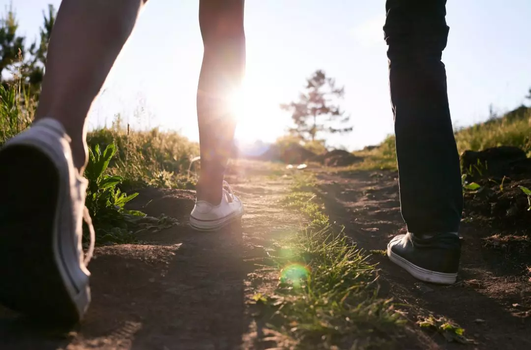 A photo of two people walking