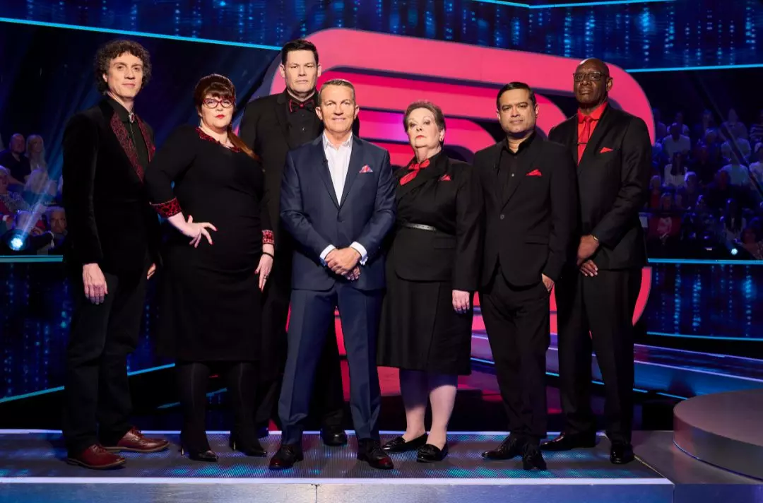 A photo shows Bradley Walsh and the Chasers posing.