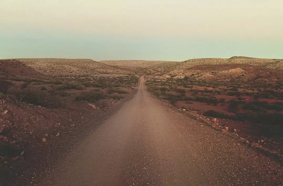 A barren and desolate desert road.