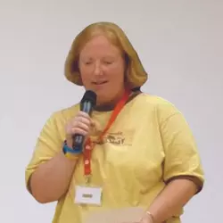 A photo of Diane Gorman speaking an at event holding a microphone